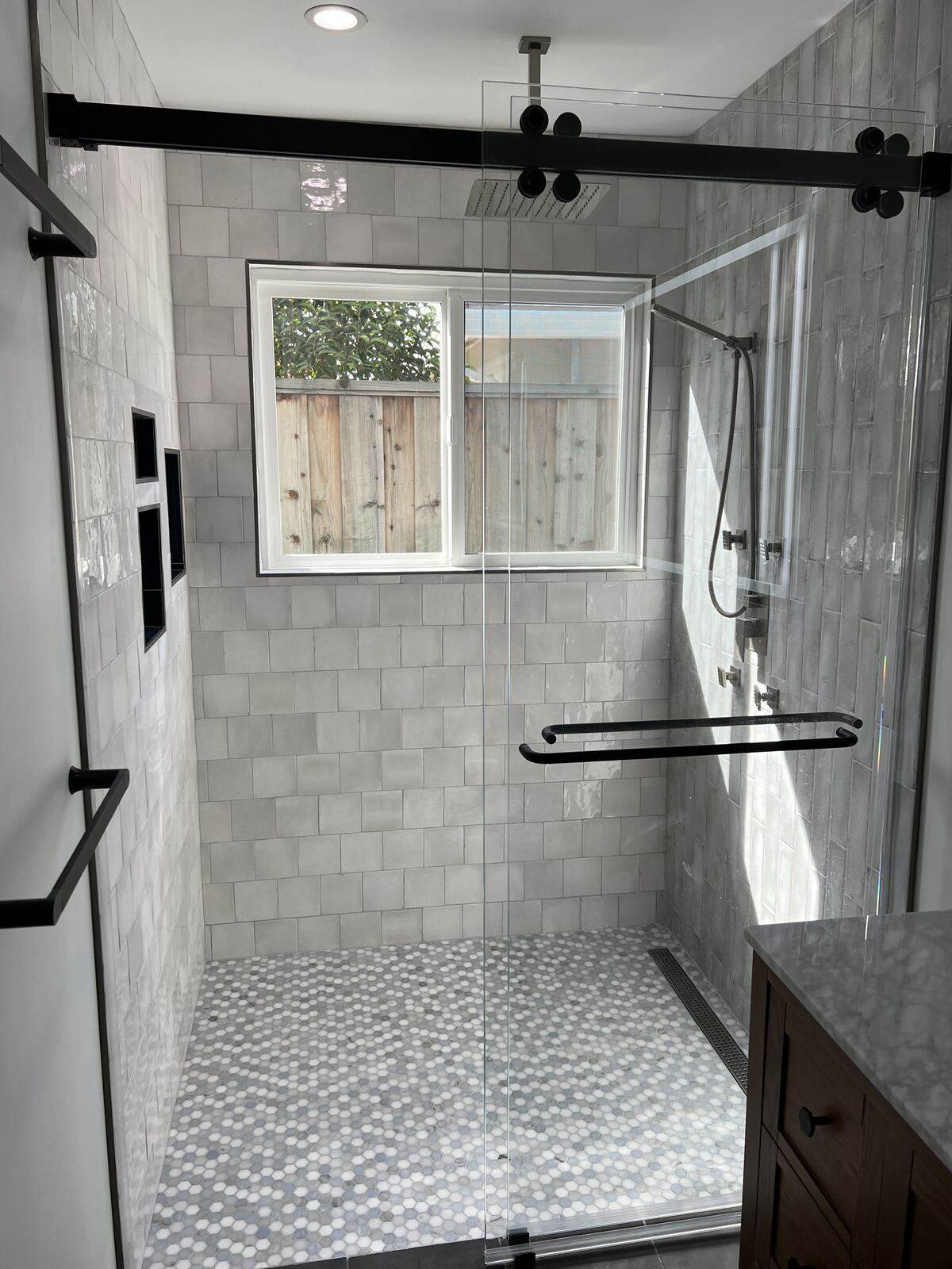 Glass shower with tile surround and window