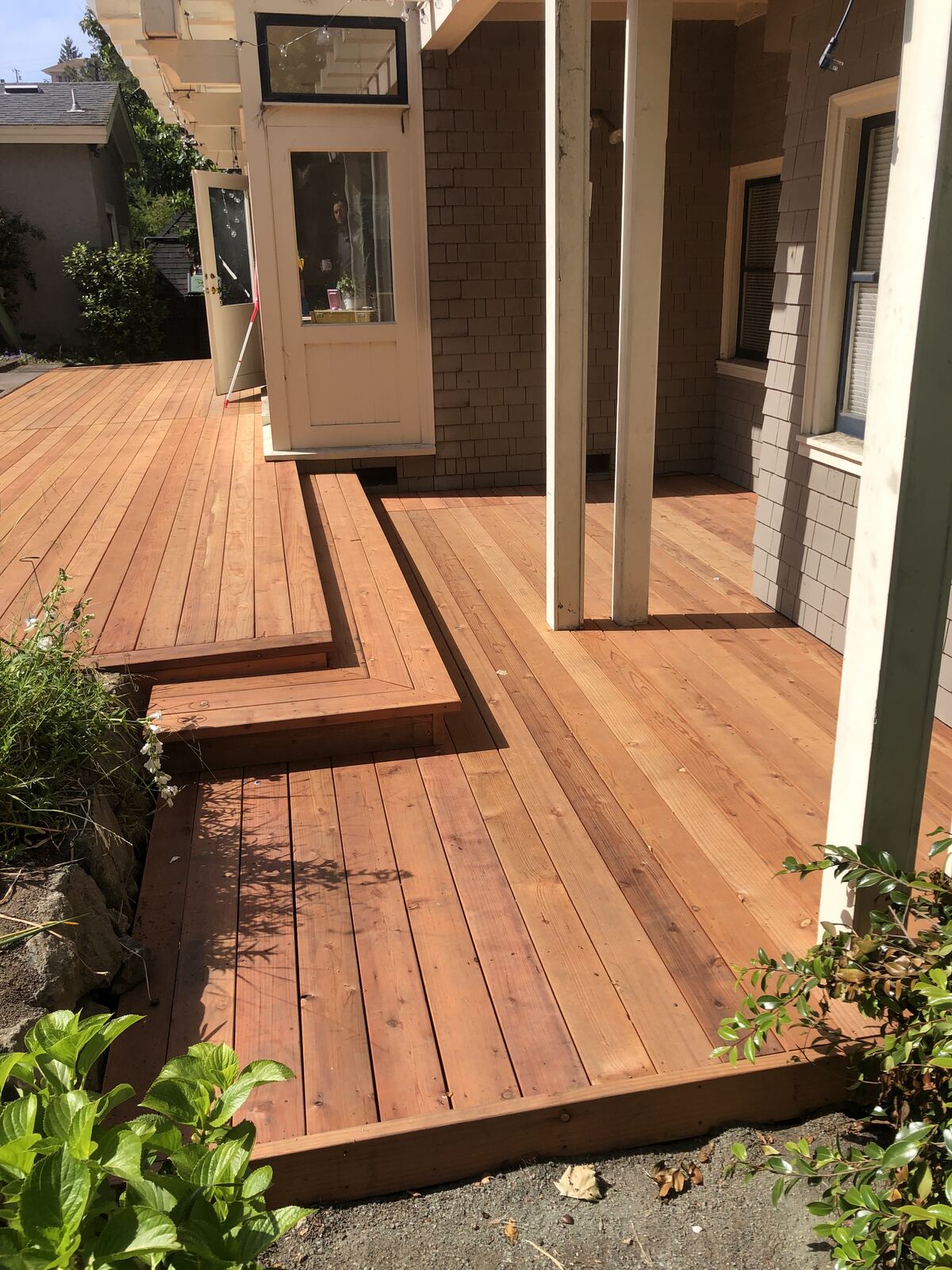 Finished redwood deck and steps built by Ironclad Construction
