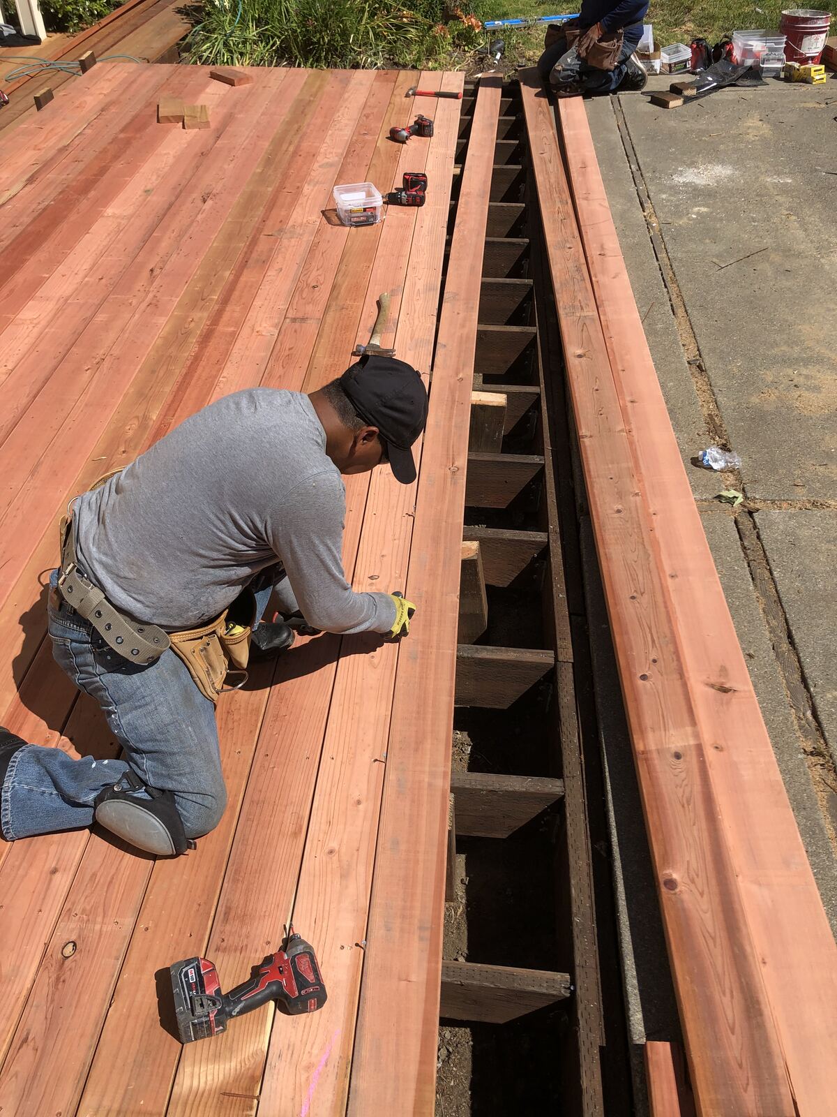 Ironclad crew installing redwood deck boards