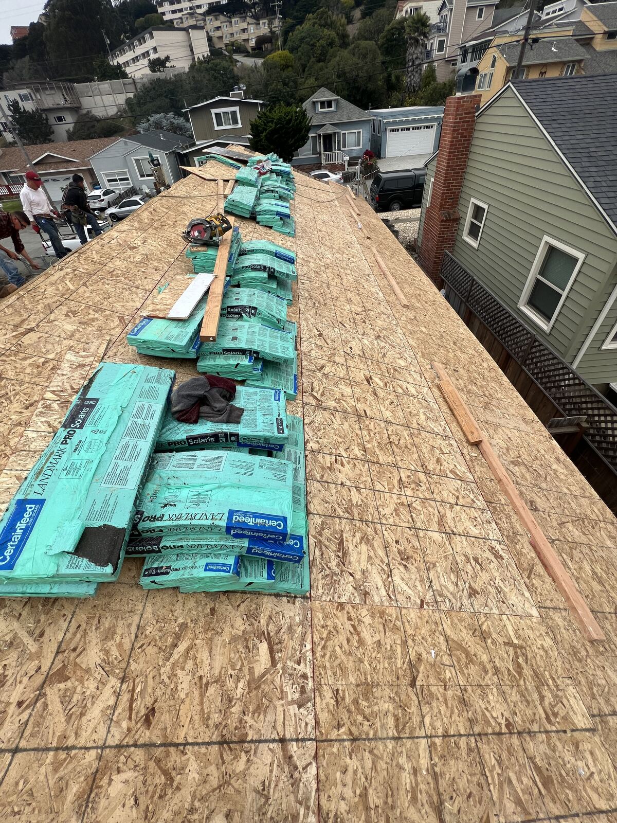 Roof sheathing installation with insulation staged