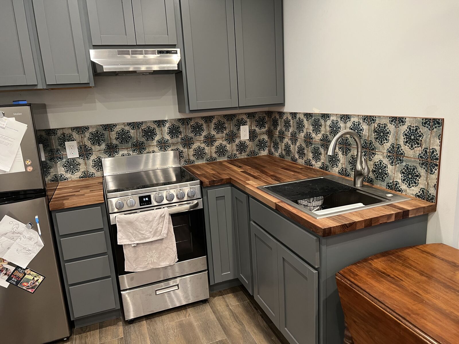 Kitchen remodel with gray cabinets and patterned tile backsplash