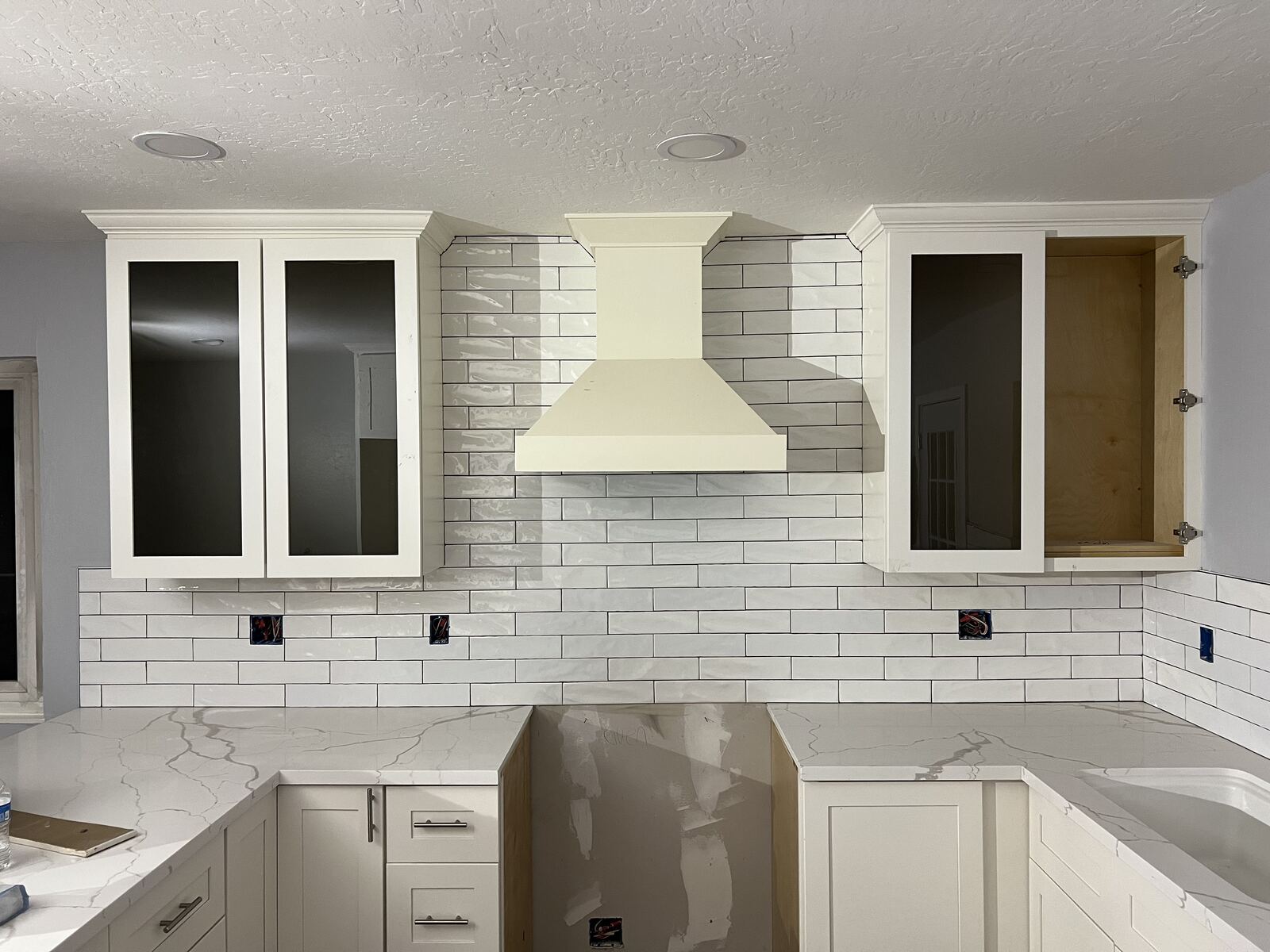Kitchen remodel in progress with subway tile backsplash